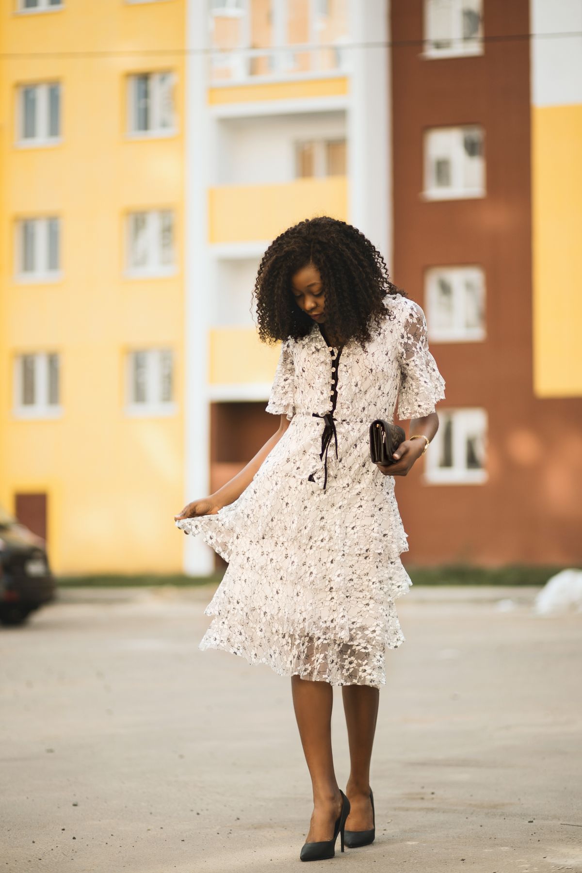 Woman in a white dress walking in an urban setting