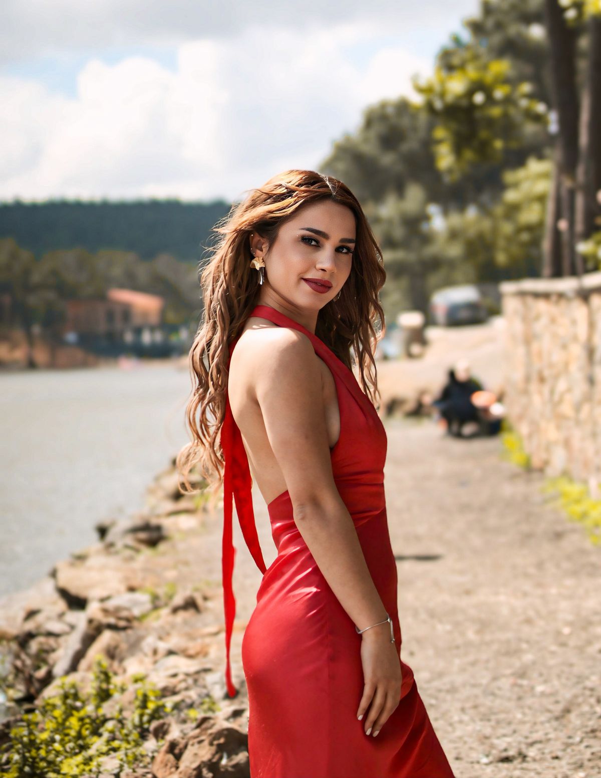 Woman in a flowing red dress outdoors