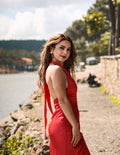 Woman in a flowing red dress outdoors
